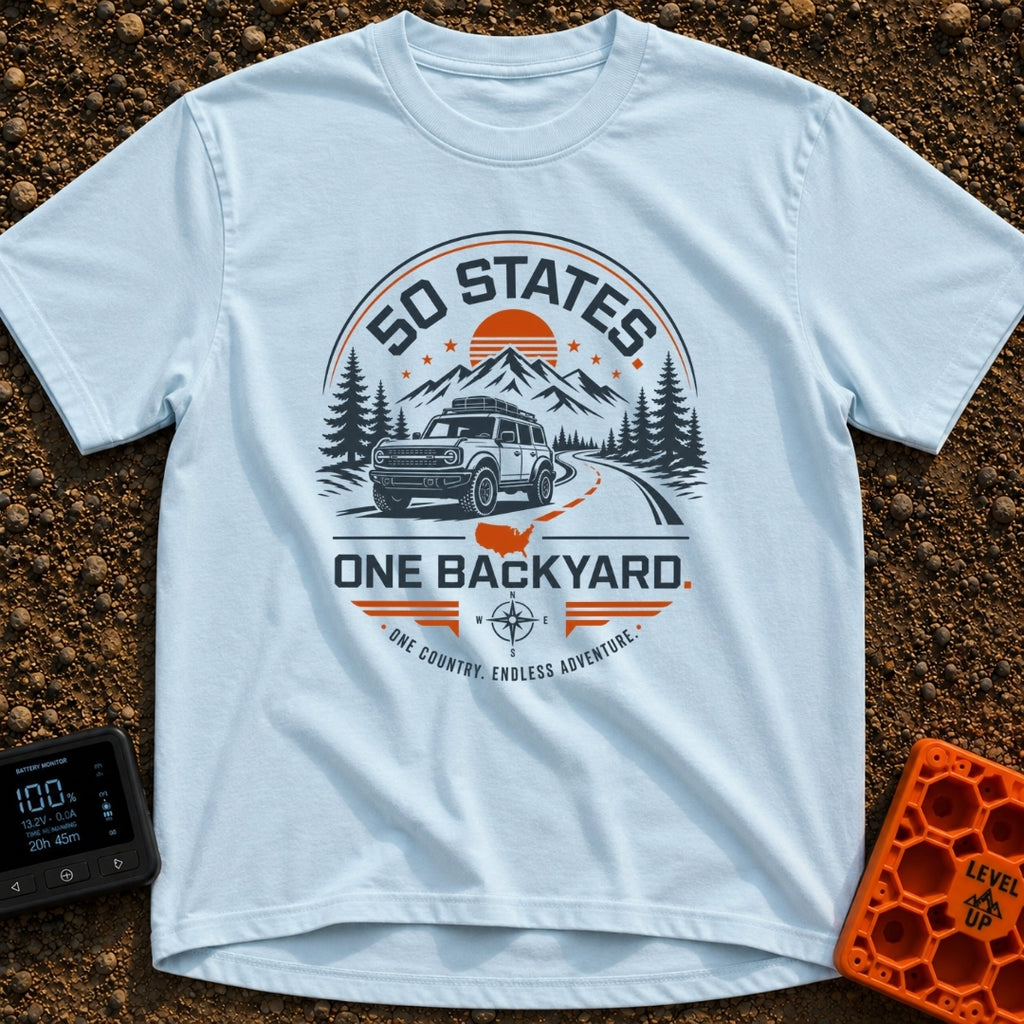 Fifty State Backyard - T-Shirt in Chambray - A circular badge design featuring an off-road SUV parked next to a winding...