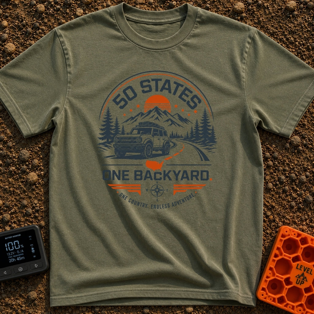 Fifty State Backyard - T-Shirt in Moss - A circular badge design featuring an off-road SUV parked next to a winding road,...