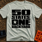 Fifty States One Backyard - T-Shirt in Bay - Bold black stacked typography that reads "50 STATES. ONE BACKYARD." with a...