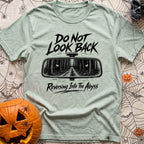 Backing Into The Abyss - T-Shirt in Bay - A black and white illustration of a vehicle's rearview mirror reflecting a dark...