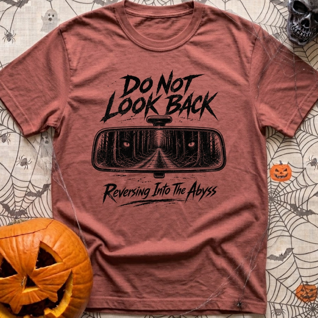 Backing Into The Abyss - T-Shirt in Brick - A black and white illustration of a vehicle's rearview mirror reflecting a...