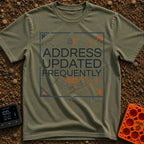 No Fixed Address - T-Shirt in Moss - The text "ADDRESS UPDATED FREQUENTLY" is centered inside a square border with...