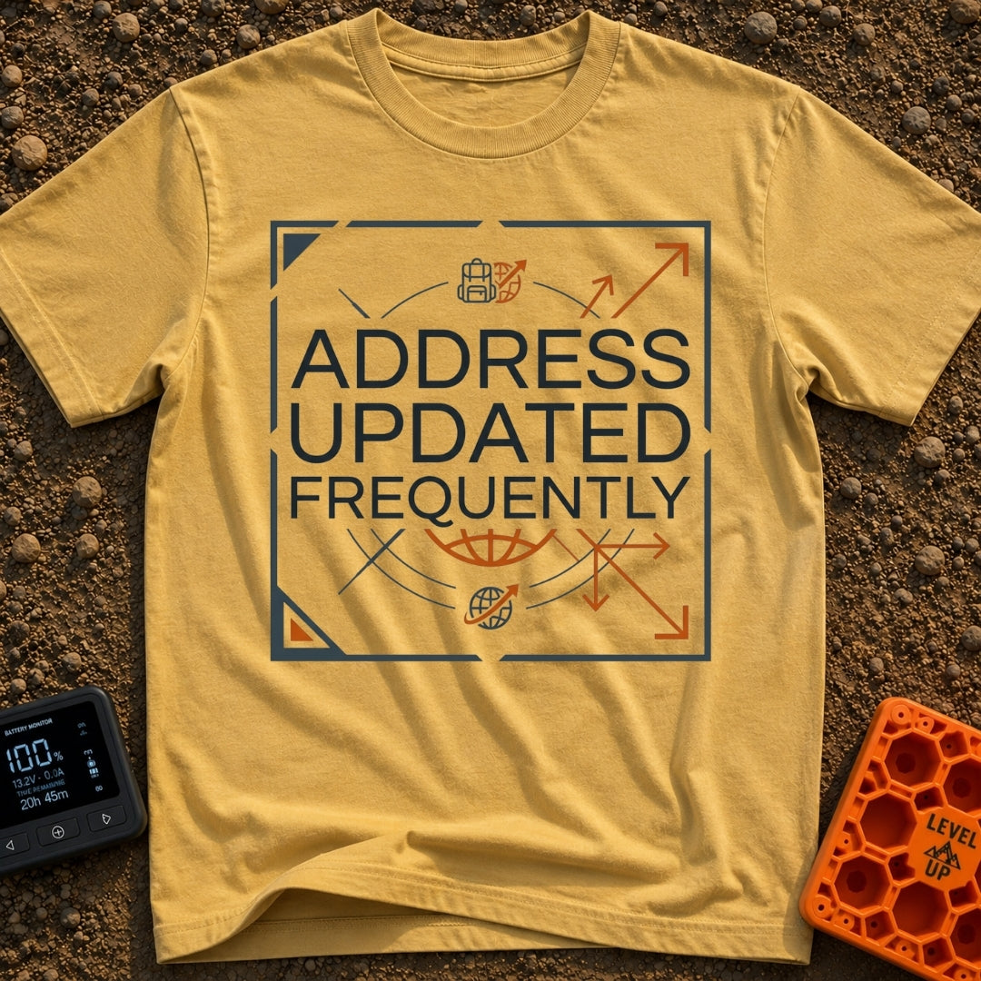 No Fixed Address - T-Shirt in Mustard - The text "ADDRESS UPDATED FREQUENTLY" is centered inside a square border with...