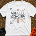 No Fixed Address - T-Shirt in White - The text "ADDRESS UPDATED FREQUENTLY" is centered inside a square border with...
