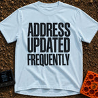 Location Not Found - T-Shirt in Chambray - A text-only design featuring the phrase "ADDRESS UPDATED FREQUENTLY" stacked...