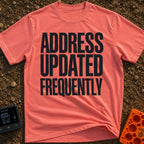 Location Not Found - T-Shirt in Watermelon - A text-only design featuring the phrase "ADDRESS UPDATED FREQUENTLY" stacked...