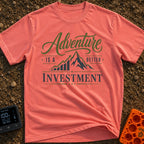Return On Adventure - T-Shirt in Watermelon - A typographic design reading "Adventure IS A BETTER INVESTMENT" featuring a...