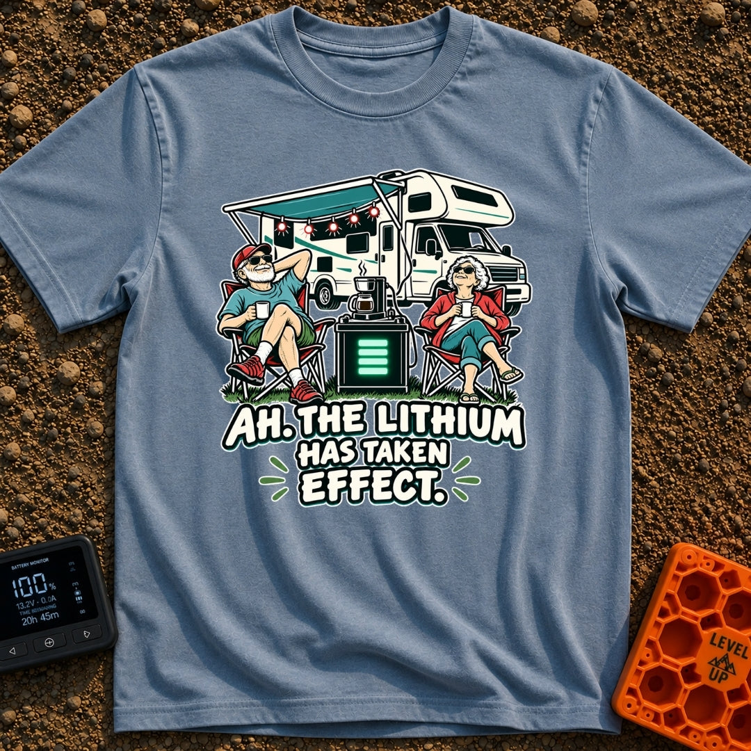 Lithium Has Kicked In - T-Shirt in Blue Jean - An older man and woman are relaxing in camp chairs drinking coffee in...