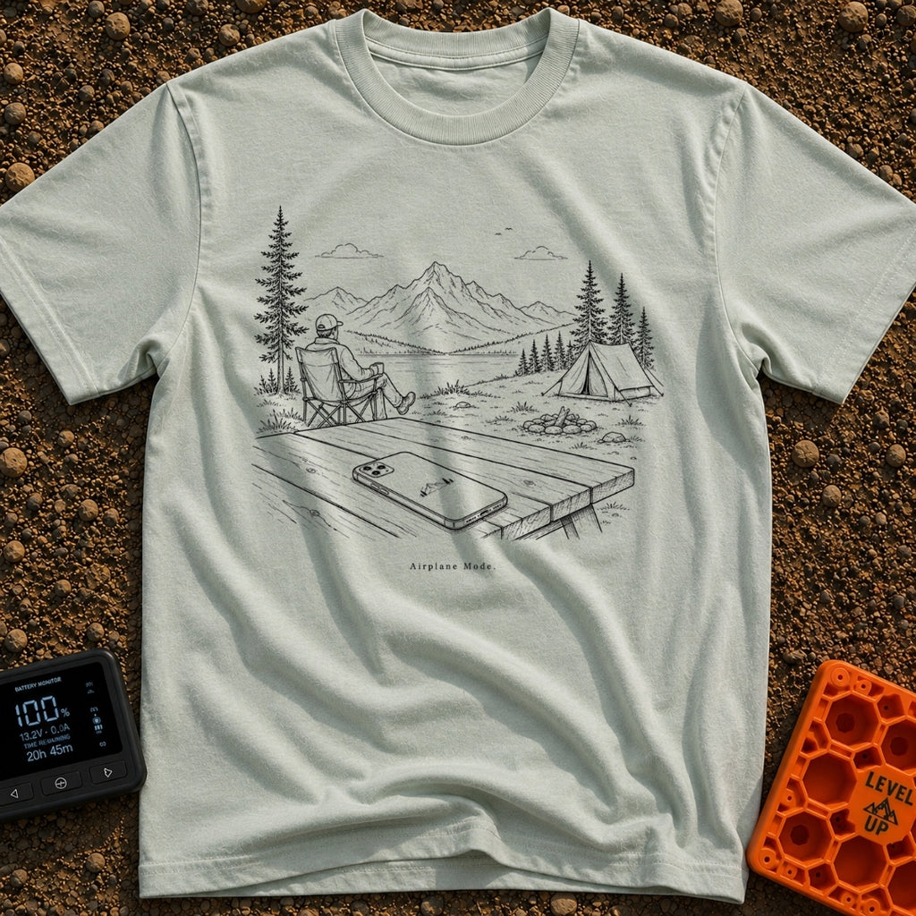 The Real Airplane Mode - T-Shirt in Bay - A black and white line drawing of a smartphone resting on a wooden picnic table...