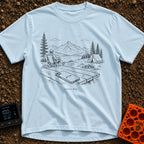 The Real Airplane Mode - T-Shirt in Chambray - A black and white line drawing of a smartphone resting on a wooden picnic...