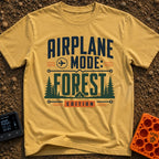 Forest On Airplane Mode - T-Shirt in Mustard - A typographic design reading "AIRPLANE MODE: FOREST EDITION" featuring an...