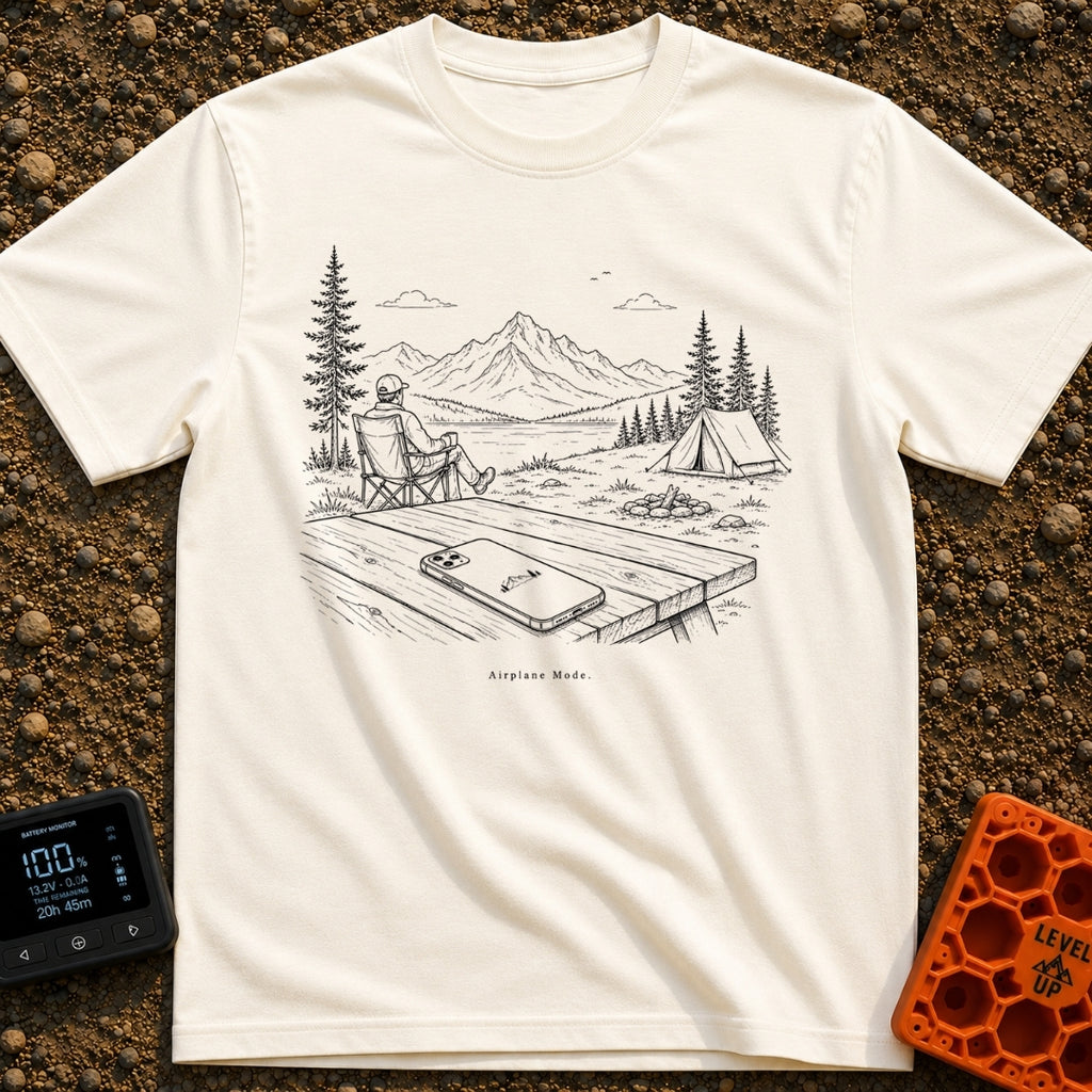 The Real Airplane Mode - T-Shirt in Ivory - A black and white line drawing of a smartphone resting on a wooden picnic...