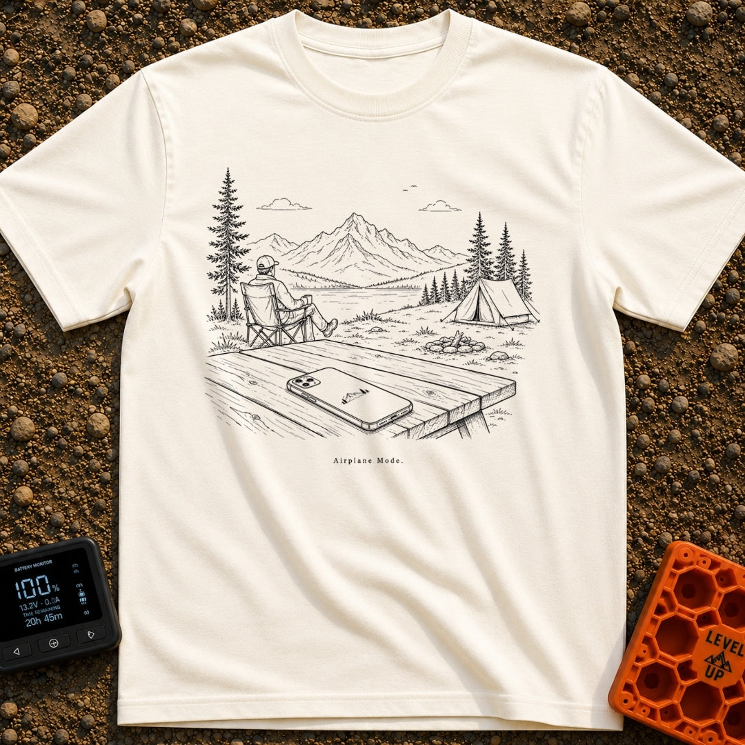 The Real Airplane Mode - T-Shirt in Ivory - A black and white line drawing of a smartphone resting on a wooden picnic...