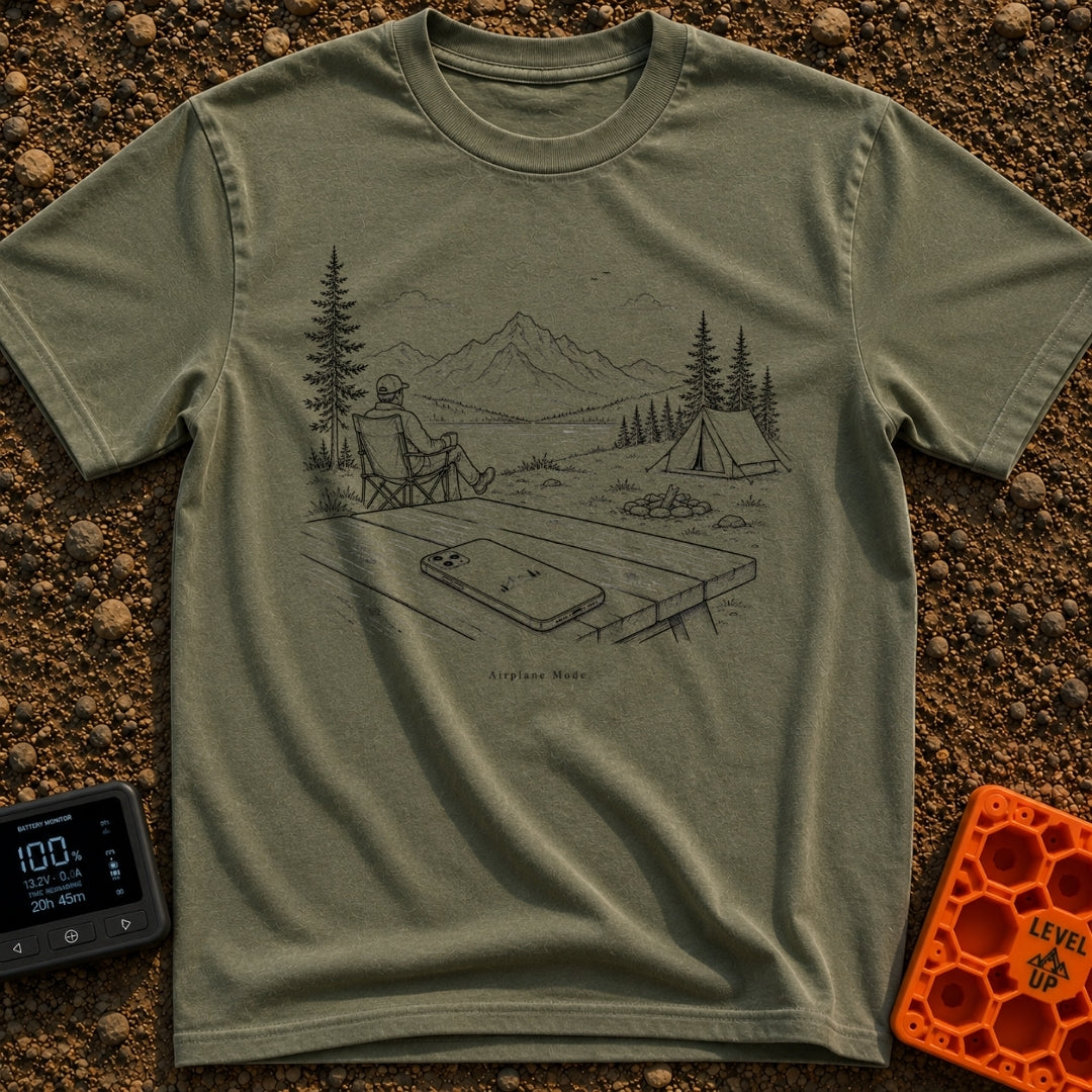 The Real Airplane Mode - T-Shirt in Moss - A black and white line drawing of a smartphone resting on a wooden picnic...