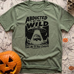 Beam Me Off Grid - T-Shirt in Moss - A black and white illustration showing a flying saucer hovering in a starry night...
