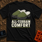 Four Wheel Lounge - T-Shirt in Black - An illustration of a pair of green, fleece-lined slippers that have thick,...