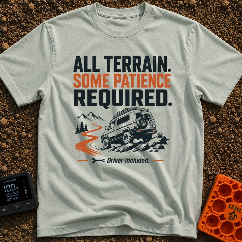 All Terrain Patience Required - T-Shirt in Bay - A rugged camper van is shown driving over a rocky surface beside a...