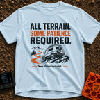 All Terrain Patience Required - T-Shirt in Chambray - A rugged camper van is shown driving over a rocky surface beside a...