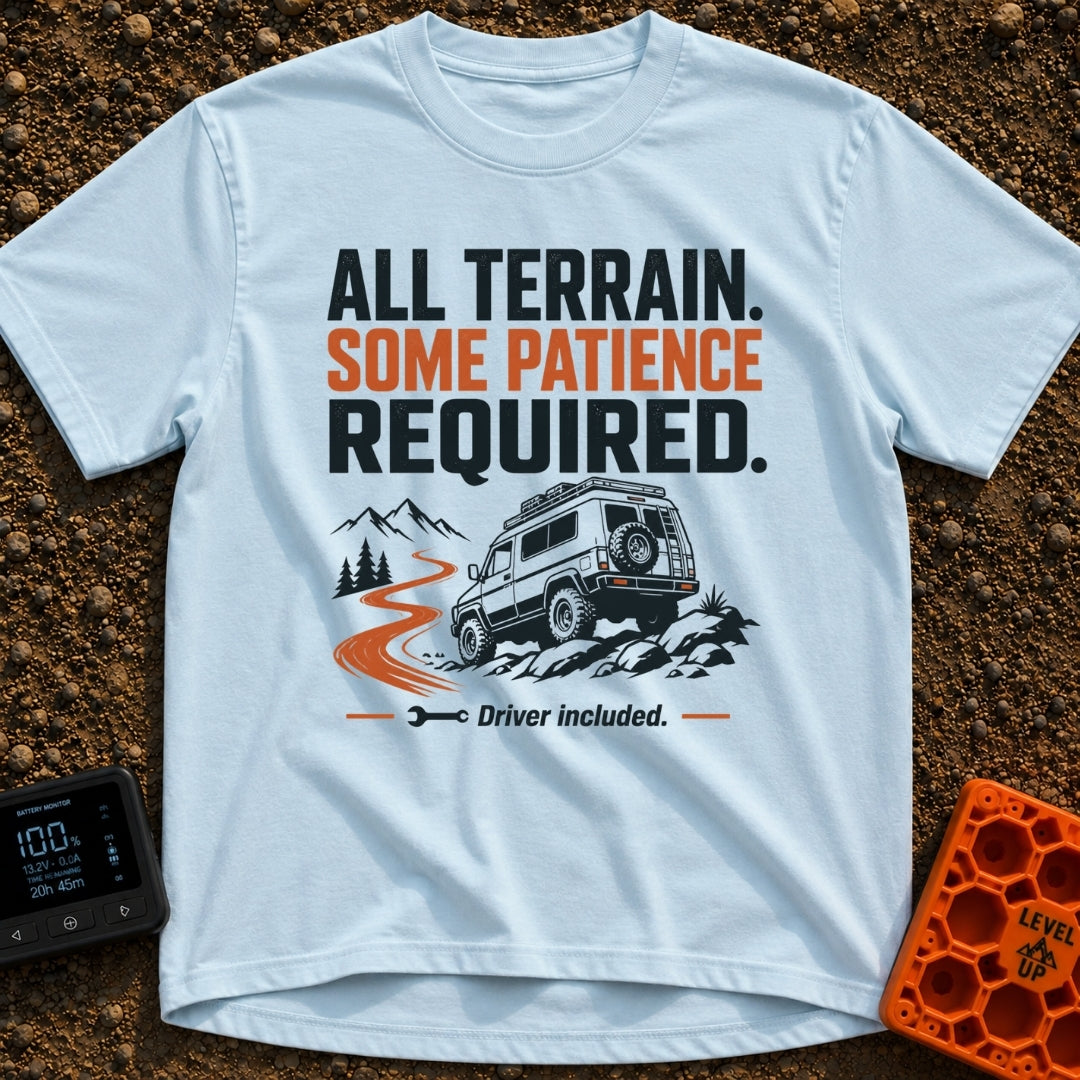 All Terrain Patience Required - T-Shirt in Chambray - A rugged camper van is shown driving over a rocky surface beside a...