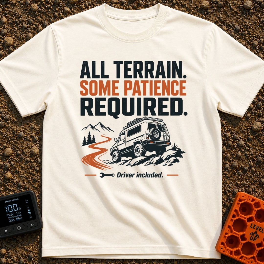 All Terrain Patience Required - T-Shirt in Ivory - A rugged camper van is shown driving over a rocky surface beside a...