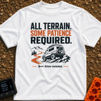 All Terrain Patience Required - T-Shirt in White - A rugged camper van is shown driving over a rocky surface beside a...