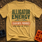 Calm Until Provoked - T-Shirt in Mustard - The artwork features the top half of an alligator's head with its eyes peering...