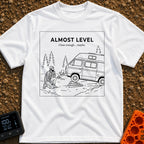 Looks Level From Here - T-Shirt in White - A black-and-white line drawing of a bearded man kneeling and thoughtfully...
