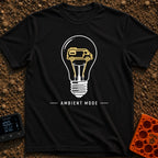 Switch To Ambient Mode - T-Shirt in Black - A black and white line drawing of a standard lightbulb featuring a glowing...