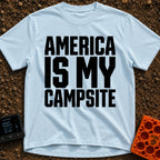 America Is My Campsite - T-Shirt in Chambray - Bold, black, uppercase text reading "AMERICA IS MY CAMPSITE" stacked in...