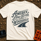 Better Through A Windshield - T-Shirt in Ivory - Stylized typography reading "America Looks Better Through A Windshield"...