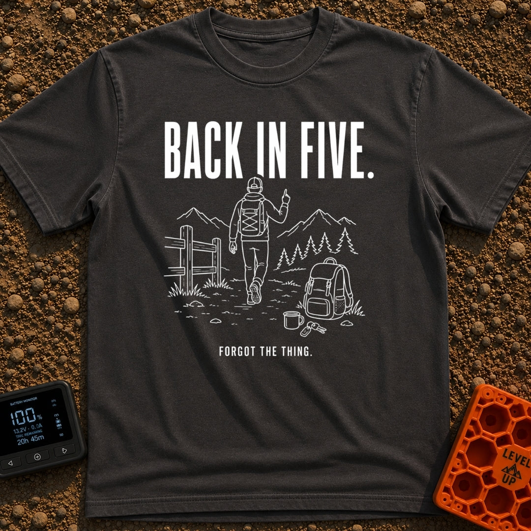Back In Five Years - T-Shirt in Graphite - White line art on a black background showing a hiker with a backpack walking...