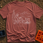 Running In The Background - T-Shirt in Brick - A line-art illustration of a man wearing a beanie sitting in a camp chair...
