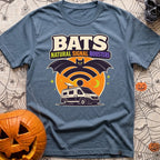Bat Signal Boosters - T-Shirt in Blue Jean - A cartoon bat forms the shape of a Wi-Fi symbol over a camper van with a...