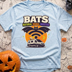 Bat Signal Boosters - T-Shirt in Chambray - A cartoon bat forms the shape of a Wi-Fi symbol over a camper van with a...