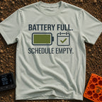 Fully Charged Life - T-Shirt in Bay - The design features the text "BATTERY FULL." and "SCHEDULE EMPTY." surrounding two...