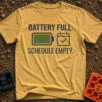 Fully Charged Life - T-Shirt in Mustard - The design features the text "BATTERY FULL." and "SCHEDULE EMPTY." surrounding...