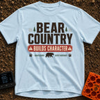 Character In Bearland - T-Shirt in Chambray - A vintage-style typographic design featuring the text "BEAR COUNTRY BUILDS...