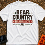 Character In Bearland - T-Shirt in White - A vintage-style typographic design featuring the text "BEAR COUNTRY BUILDS...
