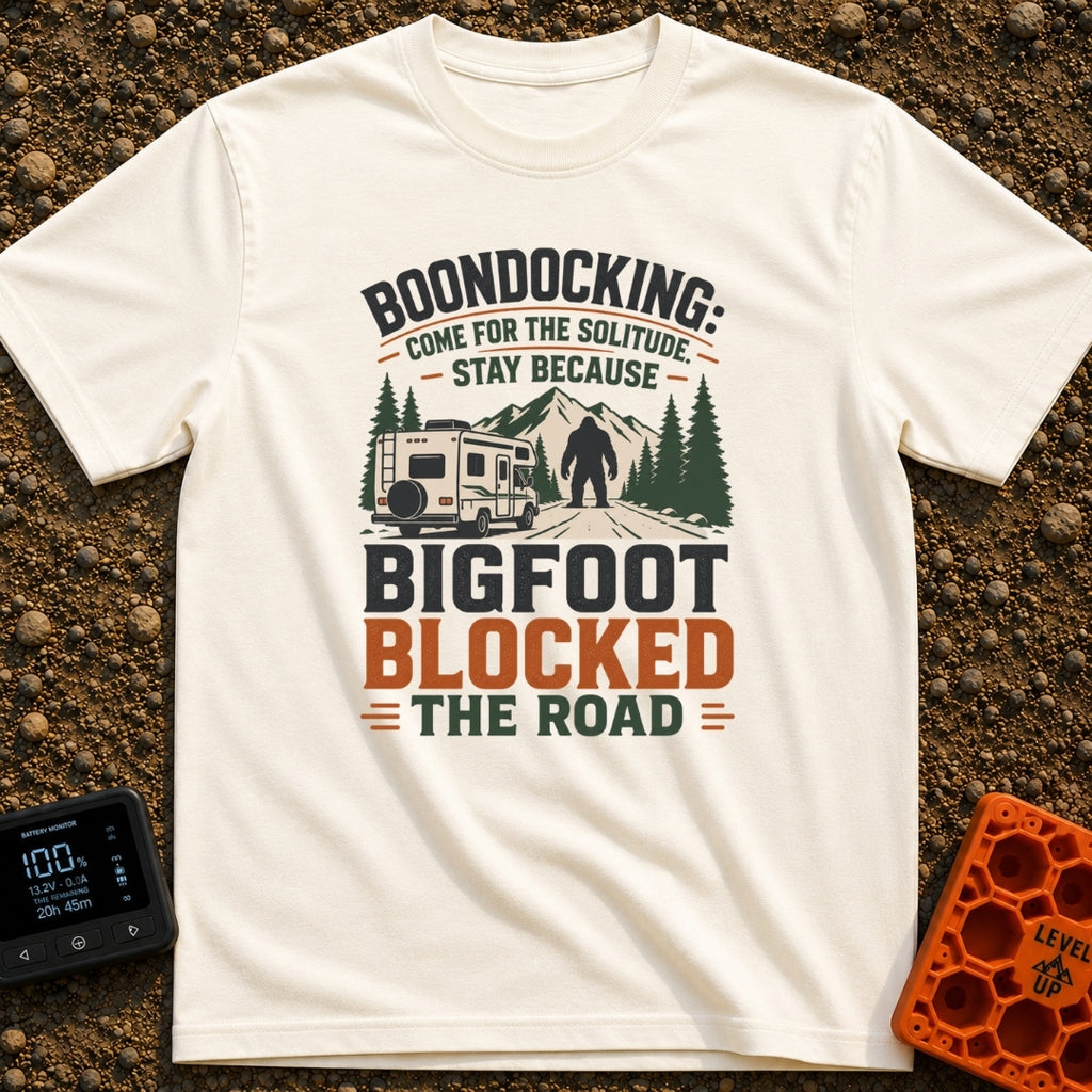 Bigfoot Right Of Way - T-Shirt in Ivory - An illustration of a Class C motorhome stopped on a dirt road facing a large...
