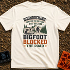 Bigfoot Right Of Way - T-Shirt in Ivory - An illustration of a Class C motorhome stopped on a dirt road facing a large...
