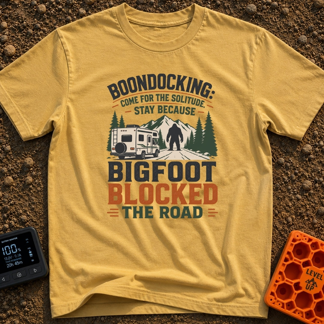 Bigfoot Right Of Way - T-Shirt in Mustard - An illustration of a Class C motorhome stopped on a dirt road facing a large...