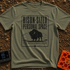 Bison Social Distancing - T-Shirt in Moss - A black and white graphic resembling a warning sign featuring an illustration...