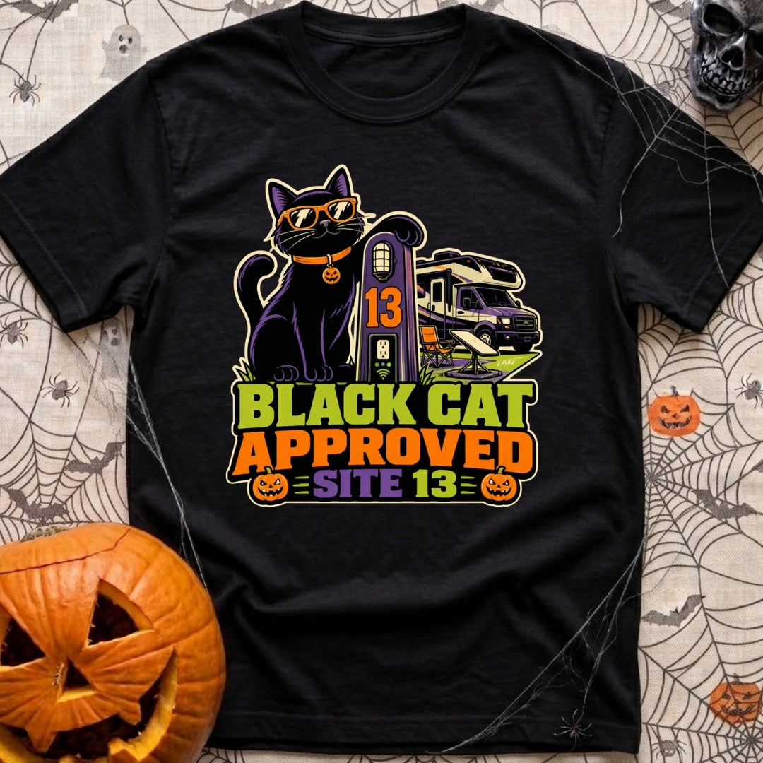 Black Cat Approved - T-Shirt in Black - A black cat wearing orange sunglasses and a pumpkin collar tag leans on a...