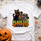 Black Cat Approved - T-Shirt in White - A black cat wearing orange sunglasses and a pumpkin collar tag leans on a...