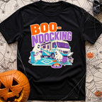Boo Ndocking After Dark - T-Shirt in Black - A cartoon illustration of two friendly ghosts setting up a campsite in front...