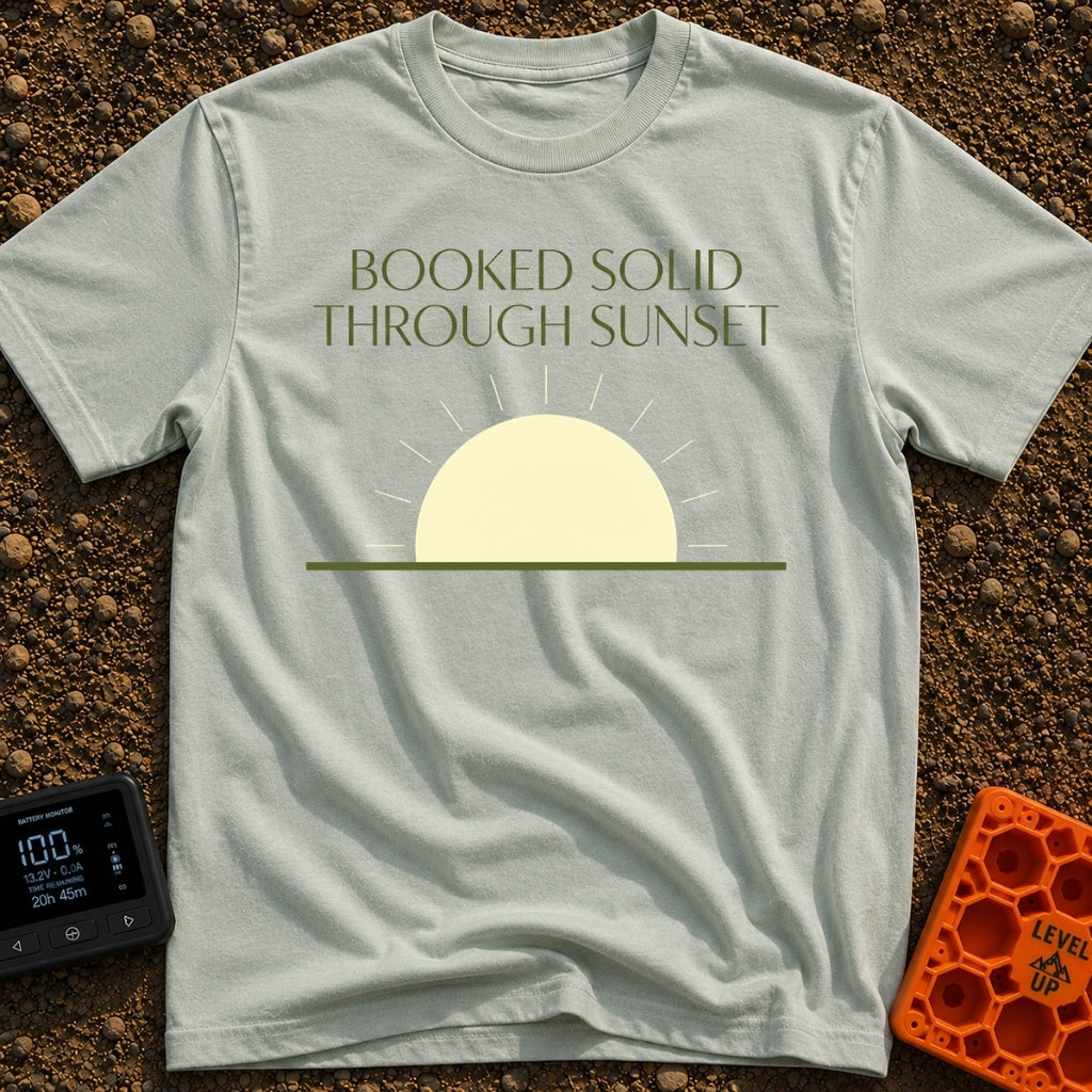 Booked Till Sunset - T-Shirt in Bay - The image features the text "BOOKED SOLID THROUGH SUNSET" in a dark olive green,...