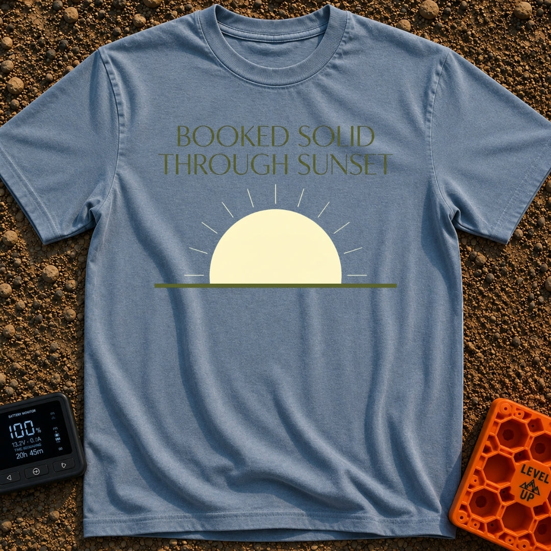 Booked Till Sunset - T-Shirt in Blue Jean - The image features the text "BOOKED SOLID THROUGH SUNSET" in a dark olive...