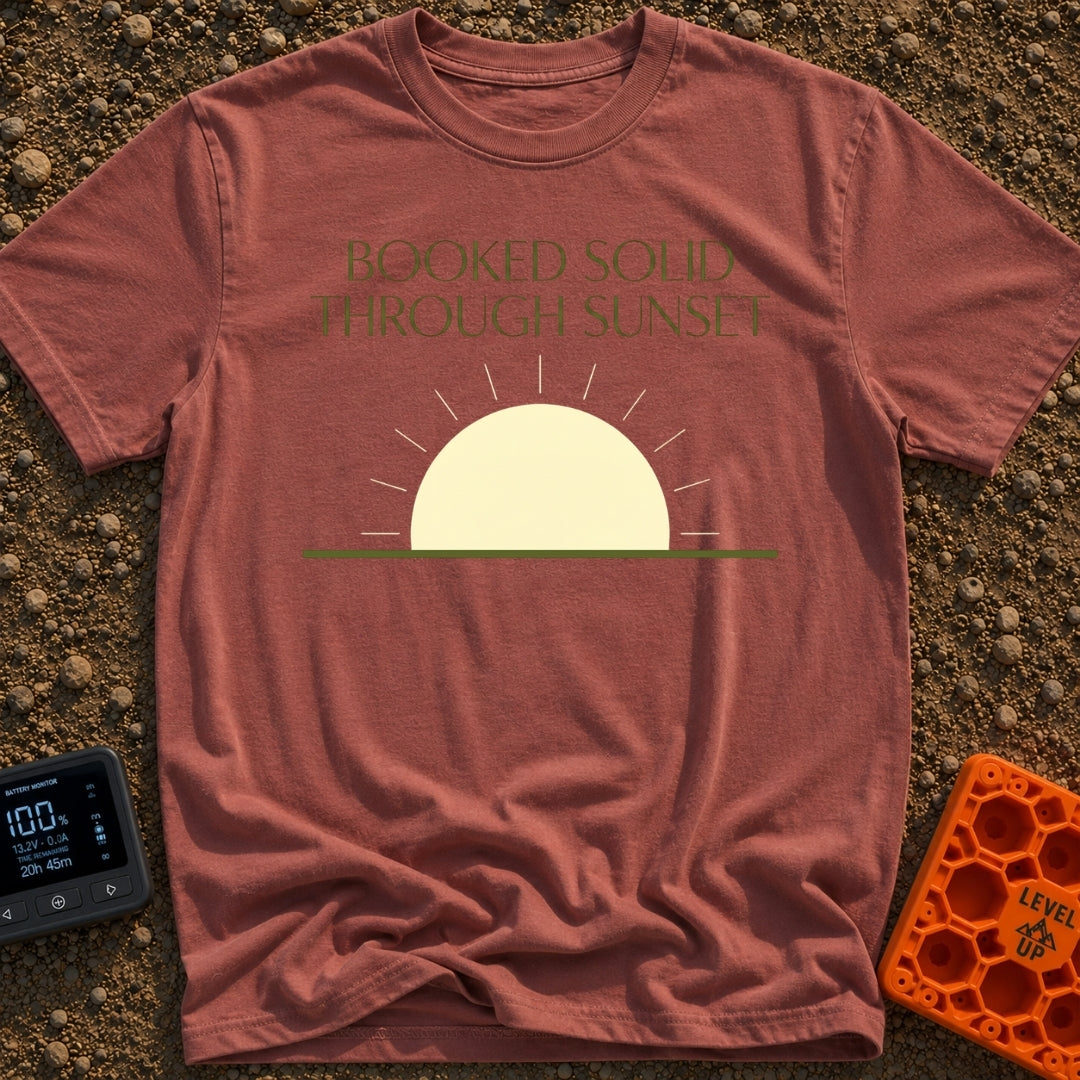 Booked Till Sunset - T-Shirt in Brick - The image features the text "BOOKED SOLID THROUGH SUNSET" in a dark olive green,...