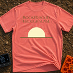 Booked Till Sunset - T-Shirt in Watermelon - The image features the text "BOOKED SOLID THROUGH SUNSET" in a dark olive...