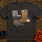 Boots Know Best - T-Shirt in Graphite - A pair of decorated brown western boots standing next to a steaming camp mug,...